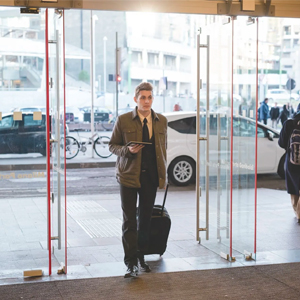 Man walking through glass door into building