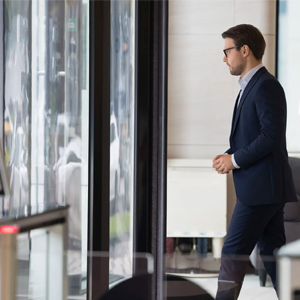 Man walking out of building through door