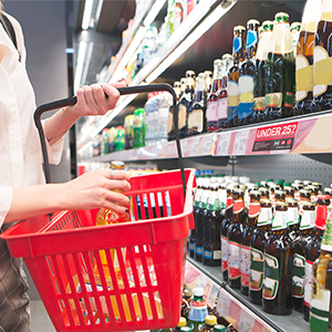 Woman buying alcohol in supermarket